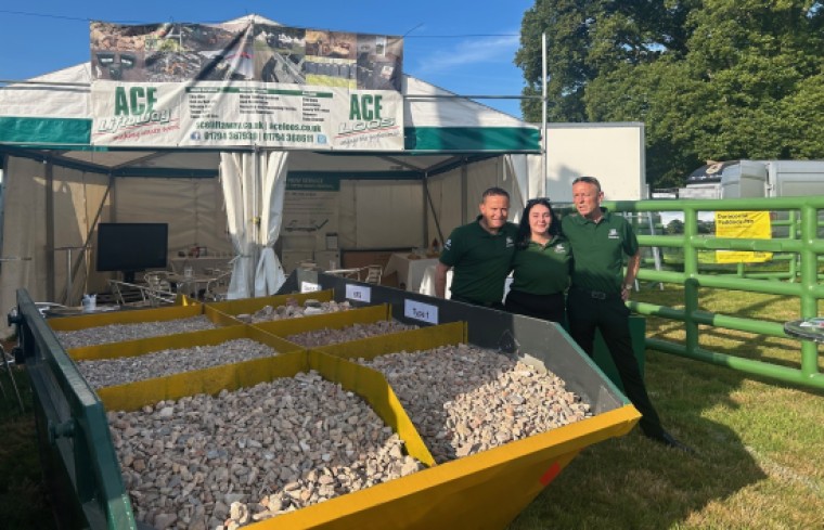 Team standing by skip of aggregates.